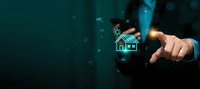 Businessman hand touching digital house icon with glowing network connections on dark teal background for real estate technology and smart home concepts.