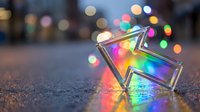 Glowing rainbow star shape with colorful bokeh lights on urban street at night creating magical festive atmosphere for holiday celebrations and decorations.