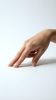 Woman's hand with manicured nails resting on white surface, showcasing skincare, cosmetics, nail care products, and beauty treatments for advertising and promotional campaigns.