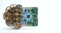 Vintage brass clockwork gears and modern green circuit board representing evolution from mechanical to digital technology on white background.