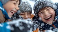 Joyful children laughing and playing in snow during winter day, wearing warm knit hats and winter coats, expressing pure happiness and seasonal fun outdoors.