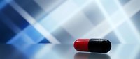 Single red and black pharmaceutical capsule on reflective surface with abstract blue geometric background for medical and healthcare concepts.