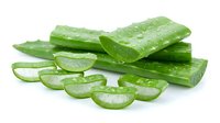 Fresh cucumber slices and whole cucumbers with water droplets on white background, isolated for culinary, wellness and food design projects.