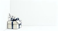 Cream gift box with navy blue ribbon and dried flower decoration on white background, isolated for holiday greeting cards and promotional designs.