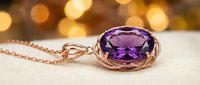 Elegant amethyst gemstone pendant with rose gold chain on soft fabric background with warm bokeh lighting, suitable for jewelry advertising and luxury product marketing.