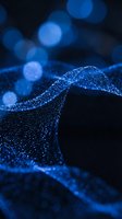 Blue glittering wave with sparkling particles and bokeh lights creating magical flowing motion against dark background for luxury design projects.