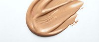 Creamy beige foundation makeup smear isolated on white background. Cosmetic product texture swatch for beauty and skincare applications.