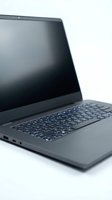 Modern laptop computer with dark screen and illuminated keyboard isolated on white background, suitable for technology and business design projects.