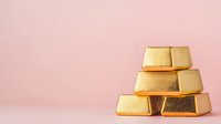Gold bars stacked in pyramid formation against soft pink background, symbolizing wealth, investment, and financial security.