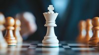 White king chess piece standing on chessboard with wooden pieces in background, dramatic lighting creates strategic atmosphere for business concepts.