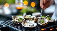 Fresh oysters on half shell garnished with herbs and sauce served on black grill plate. Luxury seafood appetizer with bokeh lights in background. Restaurant dining.