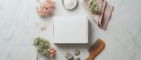 Blank white card mockup surrounded by dried flowers, wooden spoon and natural elements on marble surface for branding and stationery design projects.