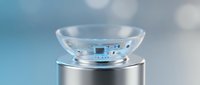 Modern smart contact lens with digital display and electronic circuits on metallic stand against soft blue background for futuristic healthcare technology.