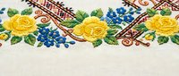 Traditional Ukrainian embroidery with yellow roses and blue flowers on white fabric. Colorful folk art pattern for cultural textile design projects.