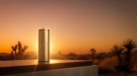 Metallic beverage can on wooden surface with desert sunset backdrop and palm trees, suitable for product advertising and beverage marketing campaigns.