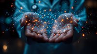 Magical glowing sparkles and light particles floating above cupped dark-skinned hands against black background, creating ethereal cosmic effect. Mystical energy concept.