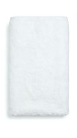 Rolled white cotton towel with soft texture, ideal for spa, hospitality, bathroom, and wellness product photography.