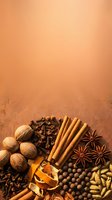 Warm spice collection arranged on textured brown background featuring nutmeg, cloves, cinnamon sticks, star anise, allspice berries, and dried citrus peel for culinary and cooking projects.