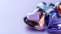 Romantic glass hearts in purple and blue tones on soft pastel background, macro photography with selective focus and bokeh effect for Valentine's day designs.