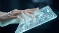 Holographic keyboard interface with human hand interacting with transparent digital display technology for futuristic computing and virtual input systems.