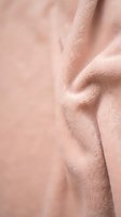 Soft pink leather texture with natural grain and wrinkles creating elegant material background for luxury fashion and interior design projects.