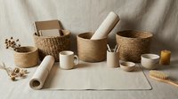 Natural woven baskets and ceramic items arranged on linen surface for home organization and sustainable living lifestyle concept.