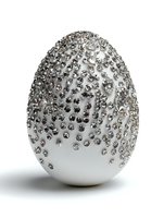Luxury white Easter egg decorated with sparkling silver rhinestones and crystals on white background for holiday celebrations and elegant decor.