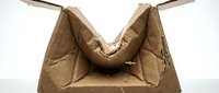 Crumpled brown paper bag with handles on white background, suitable for packaging, waste, recycling, and environmental design projects.