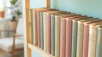 Row of vintage books with pastel colored spines arranged on wooden shelf in bright modern interior with soft natural lighting for home decor and reading.