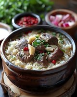 Tender braised beef with mushrooms served over steamed rice in clay pot, garnished with fresh herbs and pomegranate seeds, traditional Asian cuisine style.