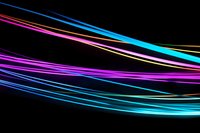 Glowing curved neon lines in blue, pink and yellow colors flow dynamically against black background creating modern abstract light trails effect.