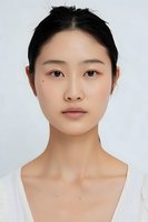 Young Asian woman with natural makeup and clean skin looking directly at camera against white background, professional portrait for beauty and skincare advertising.