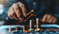 Growing investment profit shown with stacked coins and upward trending arrow graph, perfect for financial planning and business success concepts.