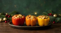 Stuffed bell peppers with meat and rice on festive table with Christmas decorations, pine branches and ornaments for holiday dinner celebration.
