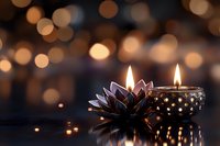 Glowing candles in decorative holders with lotus flower ornament against blurred golden bokeh background, creating peaceful atmospheric mood for spa or meditation.