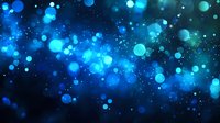 Glowing blue bokeh lights and sparkles on dark background create magical atmosphere for festive designs and holiday decorations.