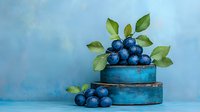 Fresh ripe blueberries with green leaves arranged on vintage blue wooden boxes against blurred blue background, food photography styling.