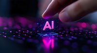 Glowing pink AI symbol on digital circuit with finger touching, representing artificial intelligence and future technology against dark background with bokeh effect.