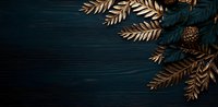 Elegant golden fern leaves and pine cone on dark teal wooden background create moody, luxurious composition for holiday season designs and festive decorations.