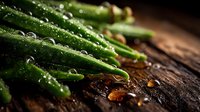 Fresh green asparagus spears with water droplets on dark rustic wooden surface in dramatic lighting, macro food photography for restaurant menu design.