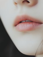 Close-up of young woman's natural pink lips and nose area showing smooth skin texture for beauty and skincare concepts.