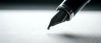 Fountain pen nib poised above white paper, ready to write or sign documents for business, education, or creative writing projects.