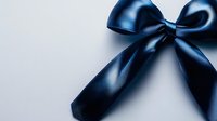 Elegant navy blue satin bow against light background, close-up view showing luxurious fabric texture and glossy finish. Suitable for gift wrapping and celebration designs.