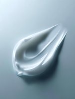 Smooth white cream swirl on gray background showing luxurious cosmetic texture and moisturizing properties for skincare and beauty product advertising.