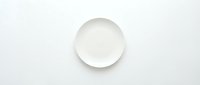 Empty white ceramic plate on clean white background isolated for kitchen and dining design projects.