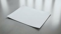 Clean white blank paper sheet on modern surface with soft shadow lighting for professional mockup and branding design projects.