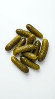 Pickled gherkins and dill cucumbers isolated on white background, ready for food packaging, recipe blogs, grocery advertising and culinary design projects.