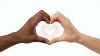Two diverse hands forming heart shape symbol representing love unity friendship and togetherness on white background isolated for design use.
