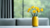 Yellow daffodils in bright ceramic vase against soft blurred background, minimalist spring home decor arrangement on windowsill creates serene atmosphere.