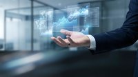 Businessman in formal suit holding digital holographic financial charts and graphs with upward trending data analytics for business growth and investment strategy.
